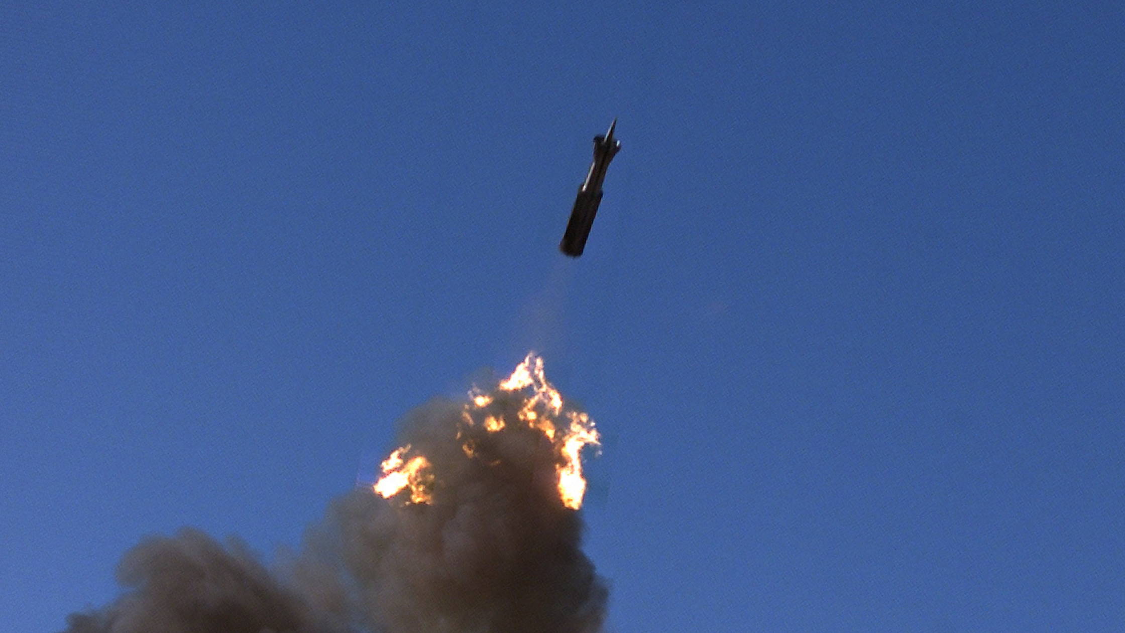 A precision guided munition being fired from the barrel of a cannon with fiery cloud of smoke.
