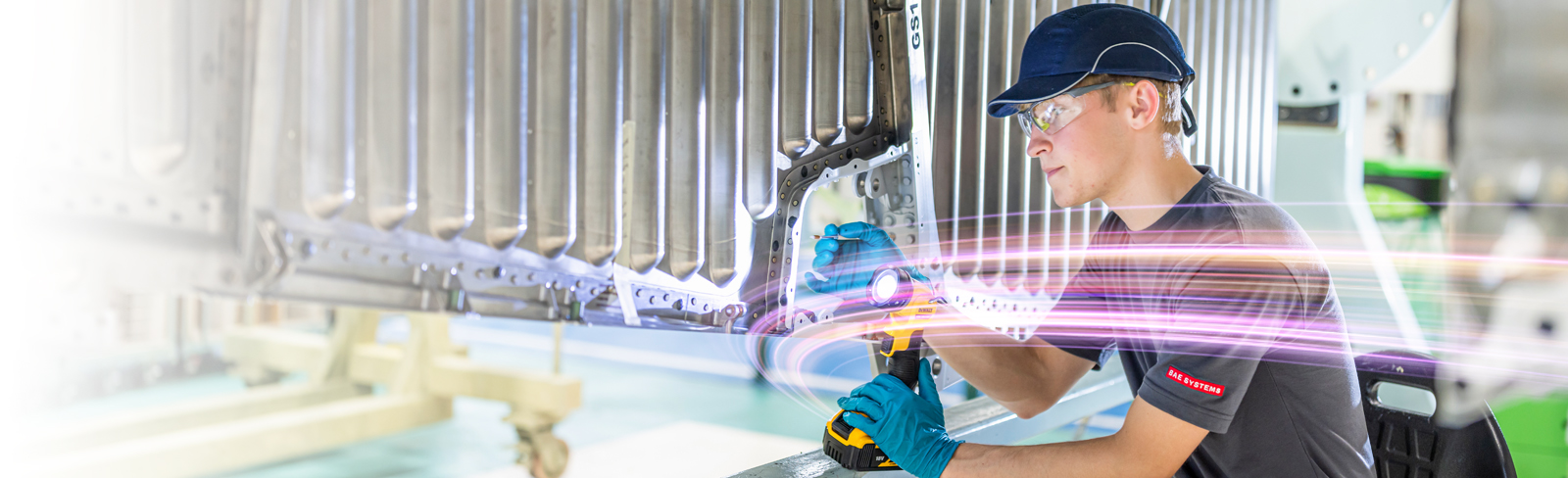 An apprentice aircraft fitter at work