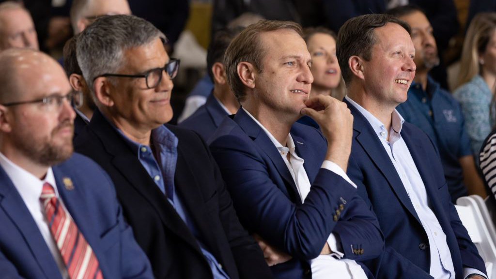 Four men sit in a group