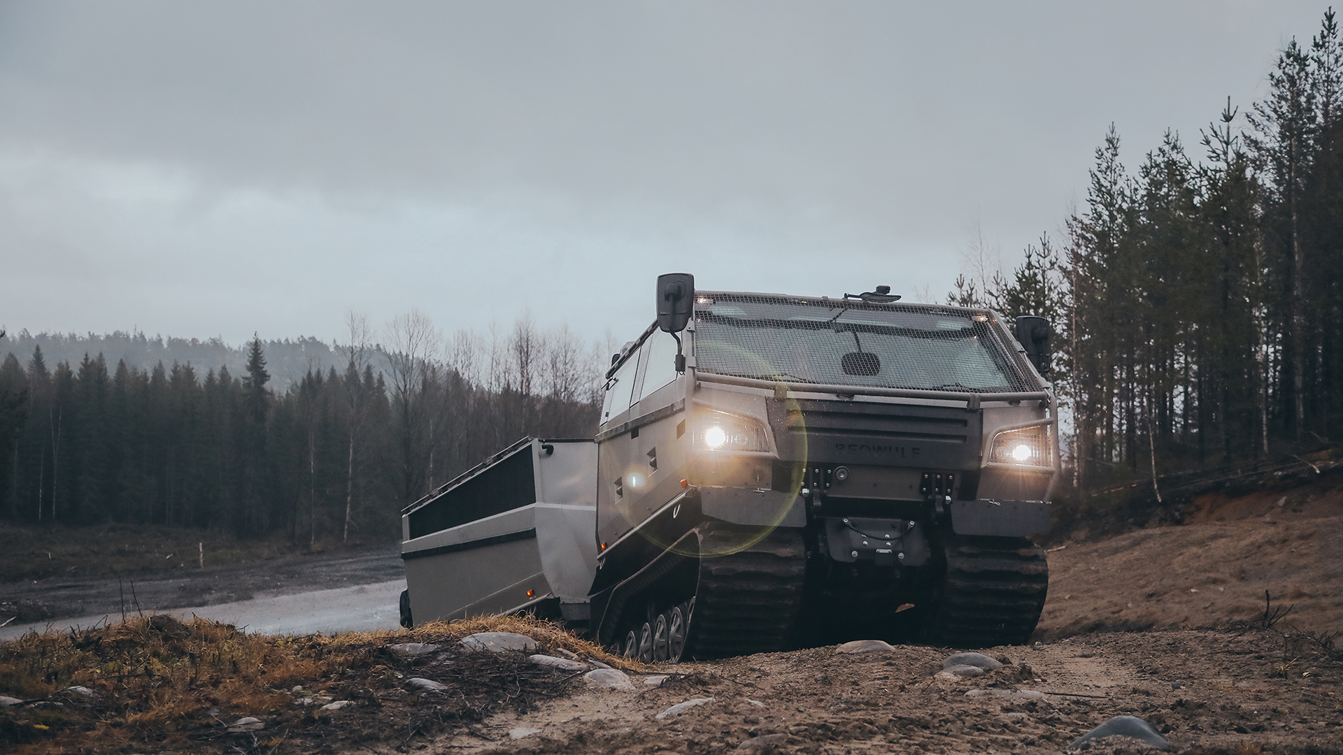 A Beowulf vehicle driving up a small hill