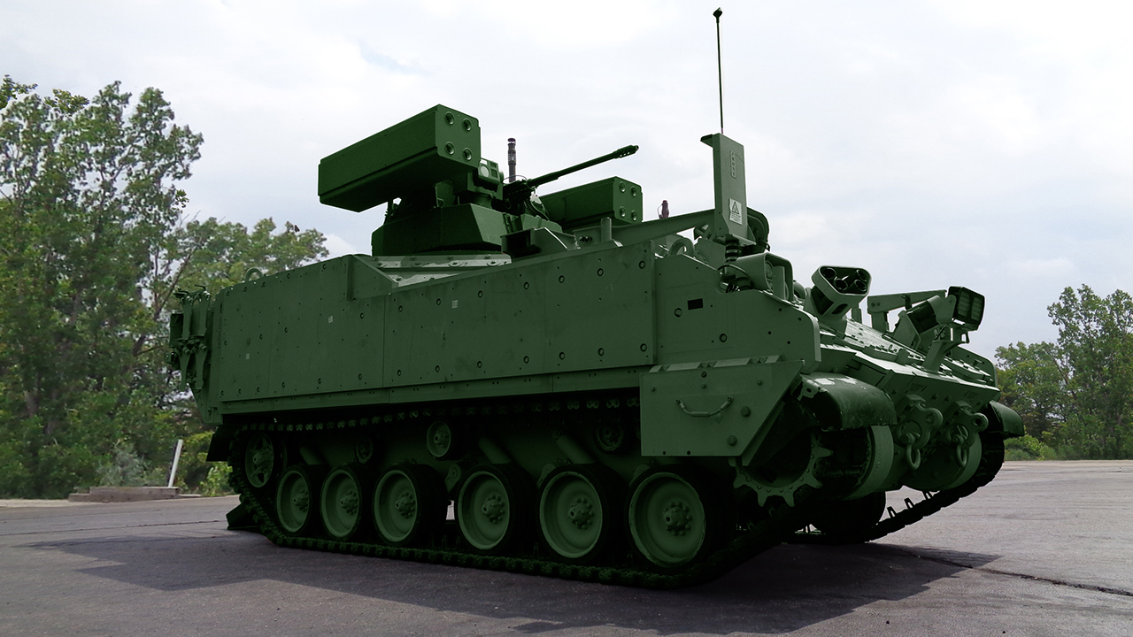 A green AMPV parked on pavement