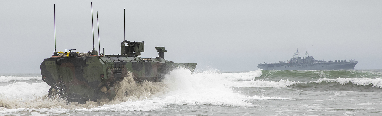 An Amphibious Combat Vehicle (ACV) with the 3d Assault Amphibian Battalion, 1st Marine Division, prepares to approach the well deck of amphibious assault ship USS Makin Island (LHD 8), July 11