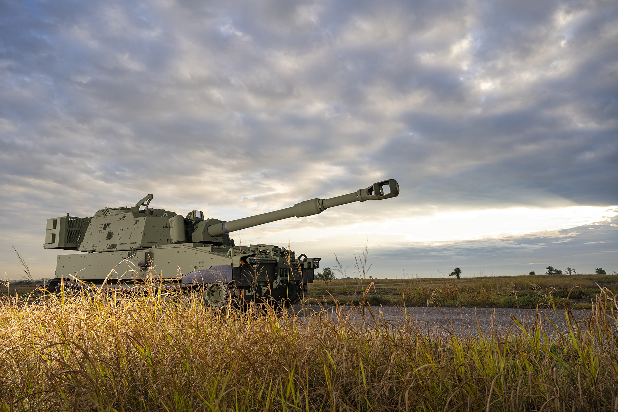 M109A7 driving down the road with a night sky
