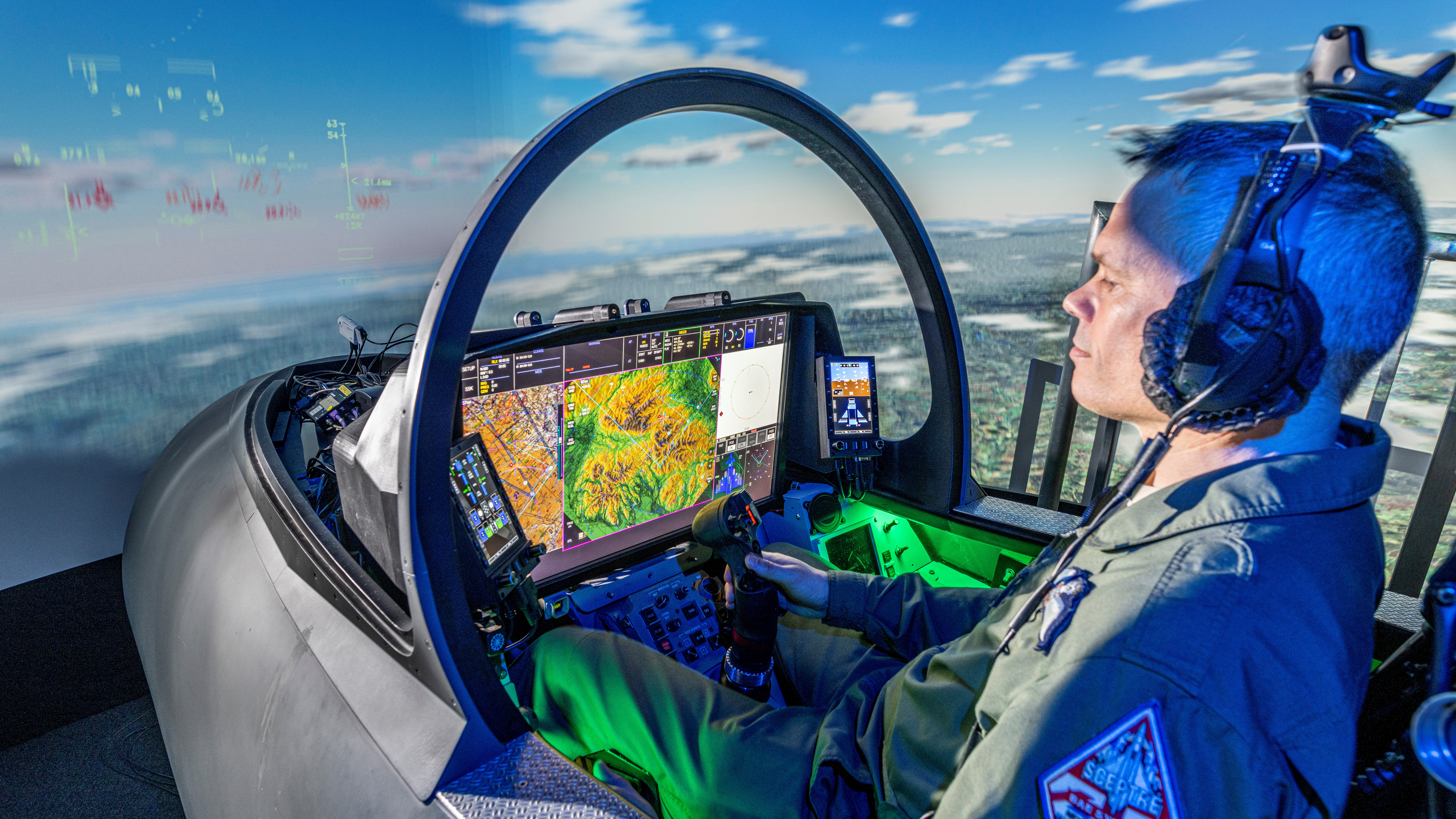 A pilot sitting in a cockpit with a Large Area Display