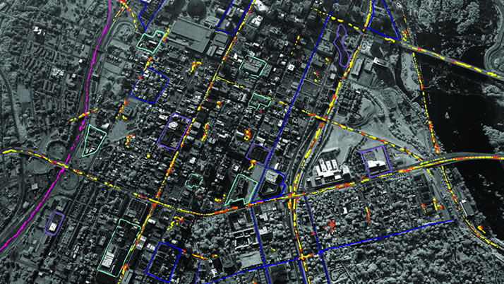 Aerial view of a densely built-up urban area with GXP Movement Intelligence – also known as MOVINT – markings showing its ability to detect, track, and exhibit target locations and activities to help analysts identify threats. 