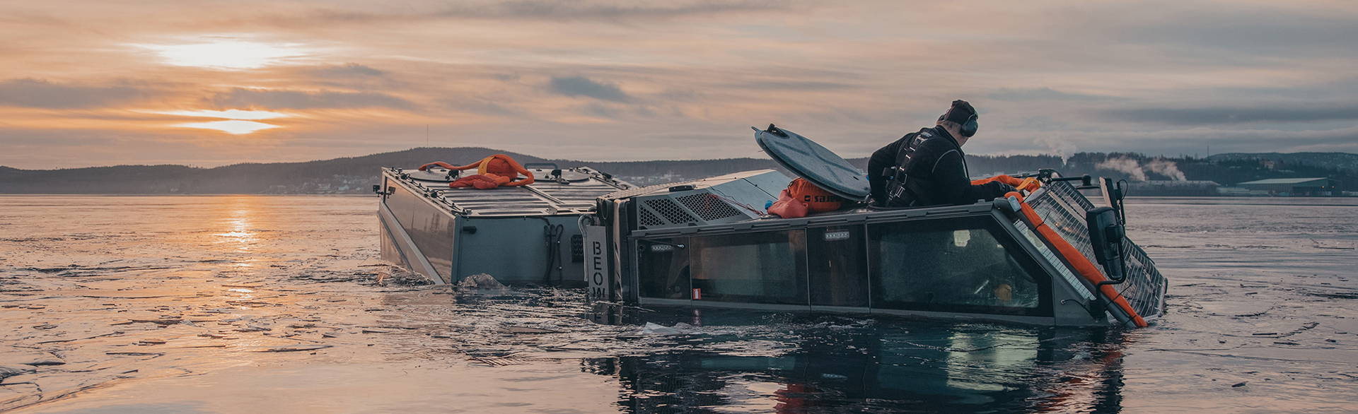 BvS10 vehicle in water at sunset